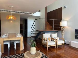 a living room with a table and a dining room at Authentic Charm C2 in Troia