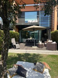 a patio with an umbrella and a table and chairs at Authentic Charm C2 in Troia