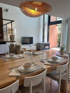 a living room with a wooden table and a dining room at Authentic Charm C2 in Troia
