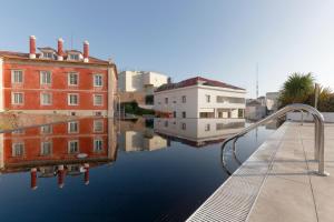 a pool of water next to some buildings and houses at Hotel Inglaterra - Charme & Boutique in Estoril