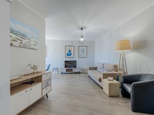 a living room with a couch and a tv at Apartment Mirasol by Interhome in Praia da Rocha