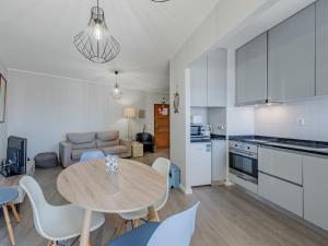 a kitchen and living room with a table and chairs at Apartment Mirasol by Interhome in Praia da Rocha +20 photos