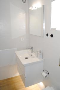a white bathroom with a sink and a mirror at Sofita Rooms in Nafplio +21 photos