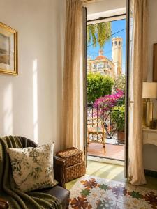 a living room with a chair and a sliding glass door at Van Gogh Flat By La Gobernanta in Alicante