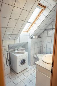 a bathroom with a washing machine and a sink at Ferienwohnung 12er in Sankt Gilgen