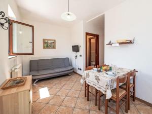 a living room with a table and a couch at Apartment Piersa by Interhome in Mergozzo