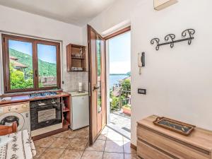 a kitchen with a door open to a kitchen with a window at Apartment Piersa by Interhome in Mergozzo