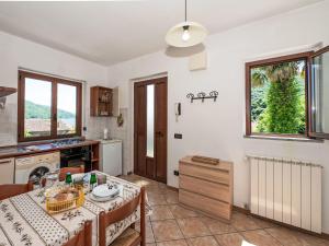 a kitchen with a table and a dining room at Apartment Piersa by Interhome in Mergozzo
