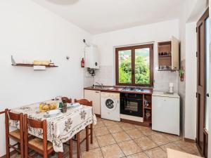 a kitchen with a table and chairs and a table and a stove at Apartment Piersa by Interhome in Mergozzo