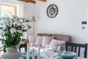 a living room with a couch and a table with wine glasses at Country house in Dziemiany