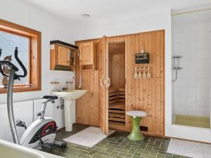 a bathroom with a treadmill and a sink and a shower at Holiday Home Extorp by Interhome in Hamneda