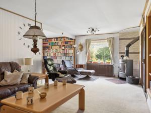 a living room with a couch and a table at Holiday Home Extorp by Interhome in Hamneda +22 photos
