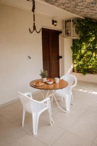 a table and two chairs and a table and chairs at Nostalgia by the Sea in Agioi Theodoroi