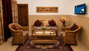 a living room with a couch and two chairs at Nature View Retreat in Rishīkesh