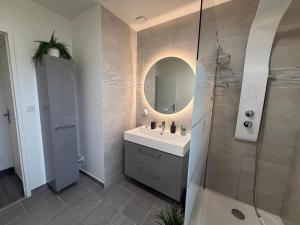a bathroom with a sink and a shower with a mirror at Escale des Grimpeurs in Milly-la-Forêt +28 photos