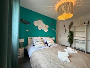 a bedroom with a bed with a green wall at Escale des Grimpeurs in Milly-la-Forêt