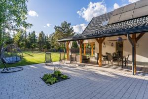 a patio with a gazebo and a playground at Country house in Dziemiany +44 photos