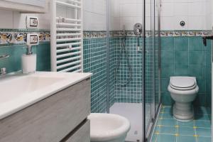 a bathroom with a toilet and a sink and a shower at Maison La Torretta in Vico Equense