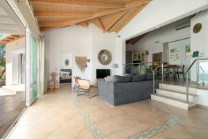a living room with a couch and a table at Villa Olivia Panoramic Sea View in Lefkada