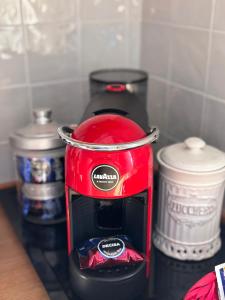 a red toaster sitting on top of a counter at Casa Virginia in Torrenieri