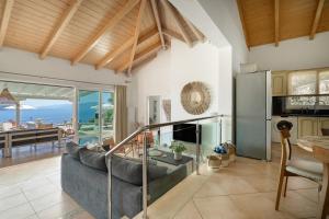 a living room with a couch and a table at Villa Olivia Panoramic Sea View in Lefkada