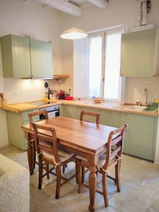 a kitchen with a wooden table and two chairs at Casa Virginia in Torrenieri +6 photos