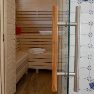 a sauna with wooden shelves and towels in it at Gulfhof bei Kletzsch Apartments & Ferienwohnungen in Großefehn Ostfriesland in Großefehn  +218 photos