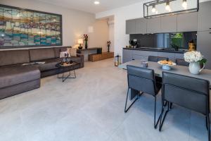 a living room with a couch and a table at CURICTA Design Apartments in Krk +92 photos