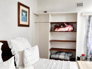 a bedroom with a bed with white pillows at The Big Five Bed and breakfast in Mooiriver
