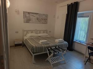 a bedroom with a bed with a chair and a window at Sole e Luna in Lonato