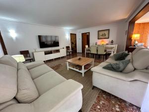 a living room with two white couches and a table at piso en puerto de Jávea in Jávea