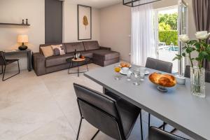 a living room with a table and a couch at CURICTA Design Apartments in Krk
