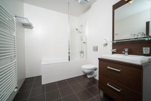 a bathroom with a sink and a toilet and a shower at Hotel Panorama in Štrbské Pleso