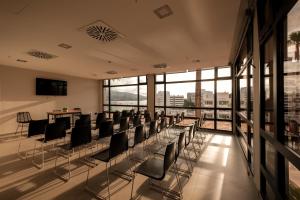 a room with chairs and tables and windows at Caramelo Calvia Beach - Adults Only in Magaluf