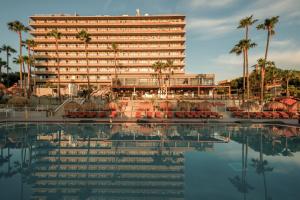 a hotel with a swimming pool in front of a building at Caramelo Calvia Beach - Adults Only in Magaluf