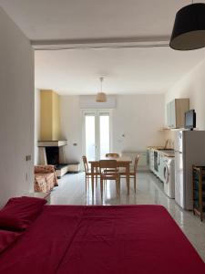 a living room with a table and a kitchen at Orsa Maggiore apartment with private courtyard in Uggiano la Chiesa +21 photos