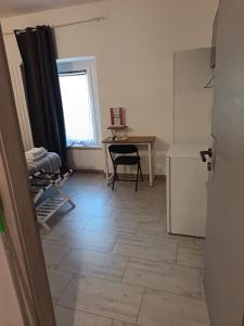 a kitchen with a desk and a table with a window at Sole e Luna in Lonato