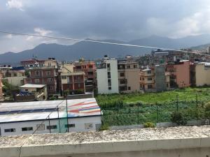 a city with buildings and mountains in the background at Konjyosom Homestay-Experience Real Nepali Hospitality in Kathmandu