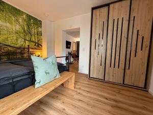 a bedroom with a couch and a large sliding door at Urlaub Schwarzwaldliebe in Bad Teinach-Zavelstein