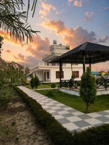 a building with a checkered path in front of it at Green Paradise 2BHK Villa with a Pool in Rishīkesh