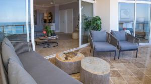 a living room with a couch and chairs and a table at 404 Oyster Rock - by Stay in Umhlanga in Durban