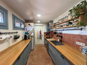 a large kitchen with a counter and a sink at Villa with privat pool La Bisbal in Vulpellach