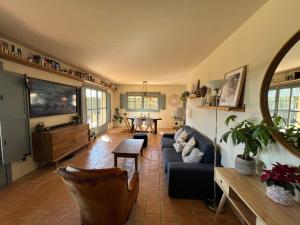 a living room with a couch and a table at Villa with privat pool La Bisbal in Vulpellach +55 photos