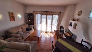a living room with a couch and a tv at Hermitage 103 in Torroella de Montgrí