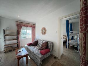 a living room with a couch and a table at Casa Buckingham 27b in Torroella de Montgrí +4 photos