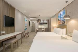 a hotel room with a large bed and a desk at Protea Hotel by Marriott Durban Umhlanga in Durban