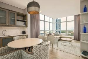 a kitchen and living room with a table and chairs at Protea Hotel by Marriott Durban Umhlanga in Durban