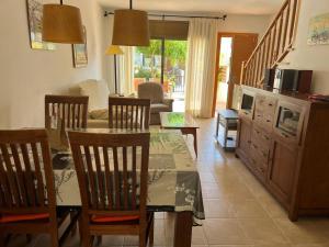 a living room with a dining room table and chairs at Sol Ric 13 in Torroella de Montgrí