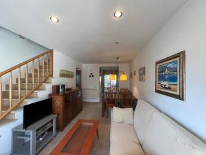a living room with a white couch and a table at Sol Ric 13 in Torroella de Montgrí