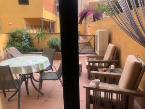 a view of a patio with a table and chairs at Ground floor apartment in Centre of Torroella De Montgri in Torroella de Montgrí +27 photos